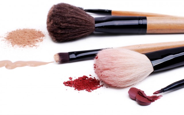Set of makeup professional brushes with sample cosmetics